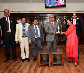 Bangalore Turf Club Committee Member Chaduranga Kanthraj Urs presenting the Royal Calcutta Turf Club Trophy to Parvati Byramji whose ward African Gold won this event at Bangalore on Friday.